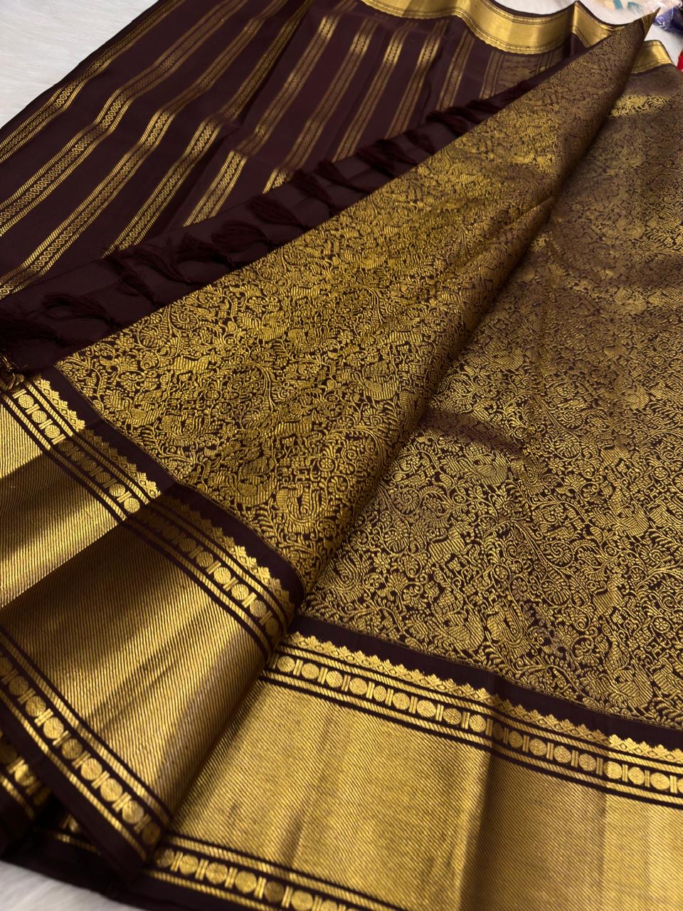 Handwoven Butta weave detail of the deep cinnamon brown Kanchipuram silk saree with Vanasringaram floral jaal