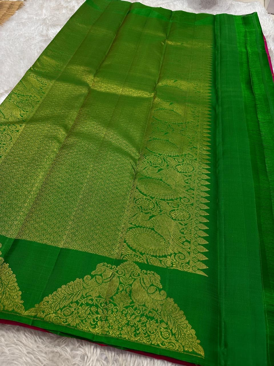Handwoven raspberry pink Butta Kanchi Pattu silk saree, folded