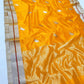 Daytime occasion look in a marigold yellow Chanderi Pattu Silk saree with silver-gold border