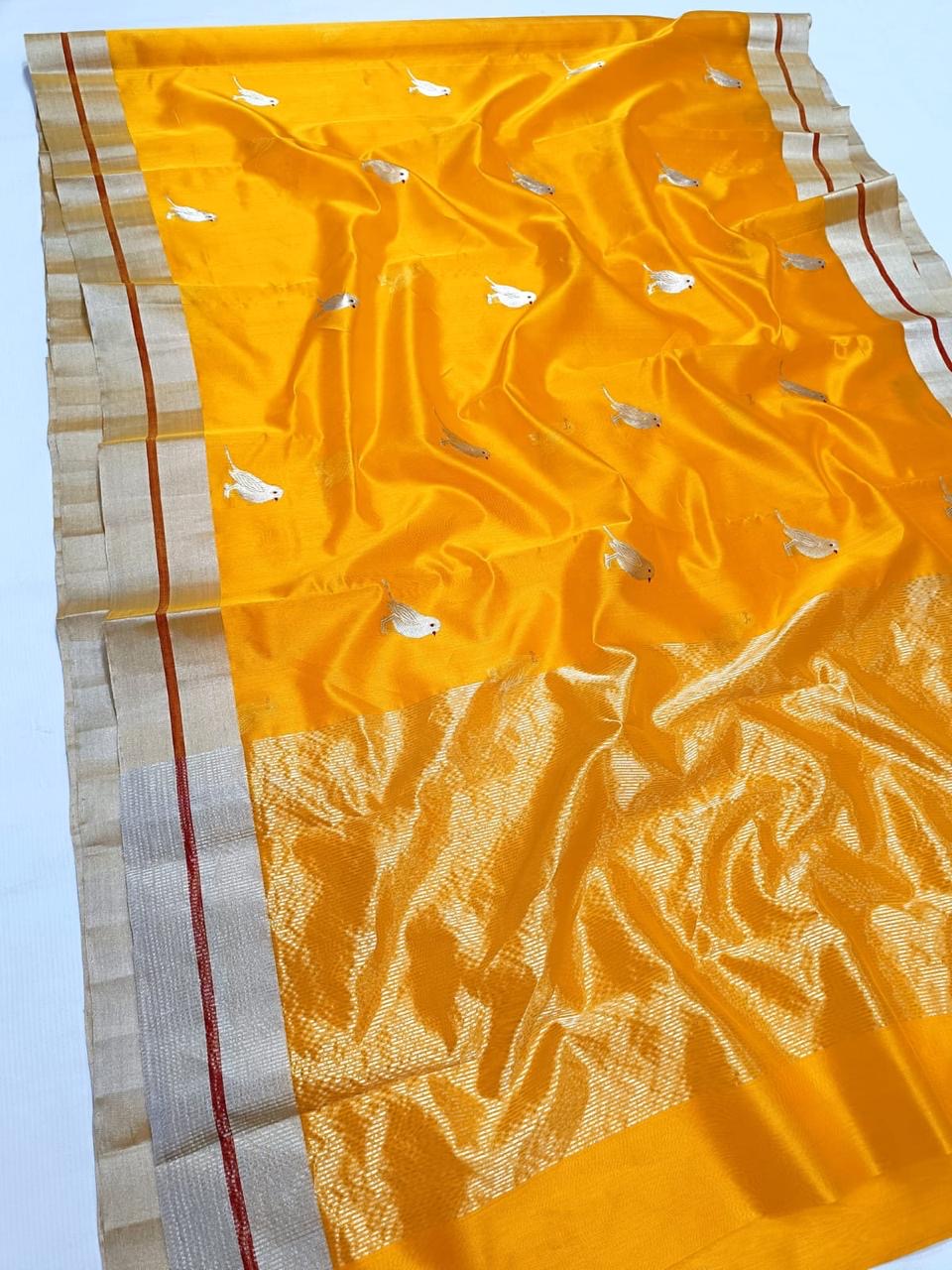 Daytime occasion look in a marigold yellow Chanderi Pattu Silk saree with silver-gold border