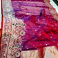 Close detail of the shimmering silver-rose pallu on a berry red Chanderi Katan Silk saree