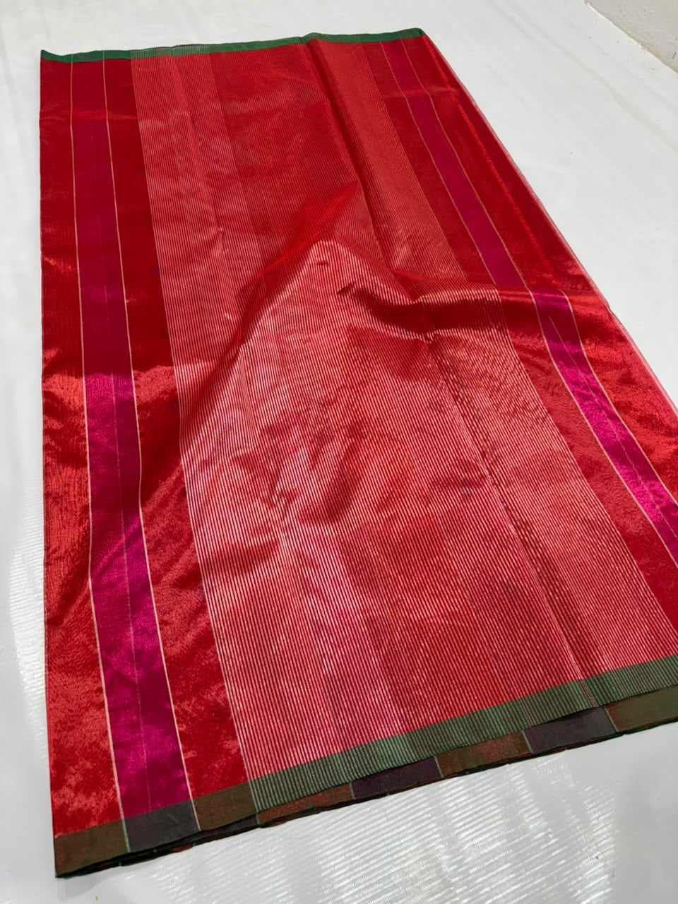 Handloom red Tissue Silk Chanderi pallu with closely woven metallic pinstripes and narrow green edging