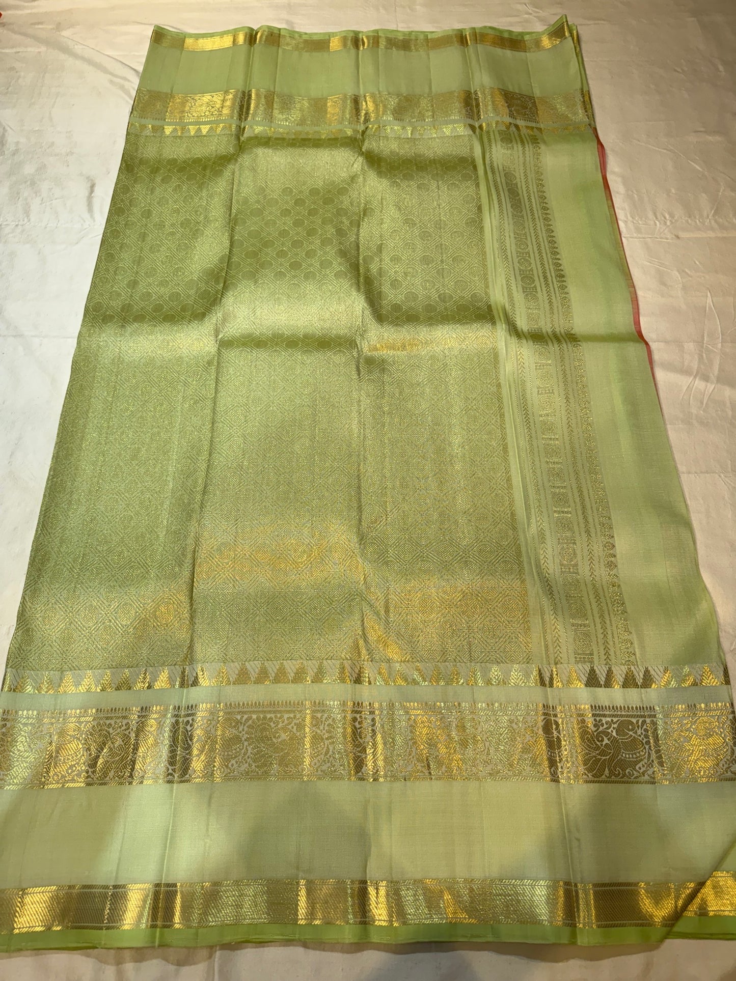 Folded view of golden peach and parrot green rettapet korvai Kanchipuram silk saree — Idam Living
