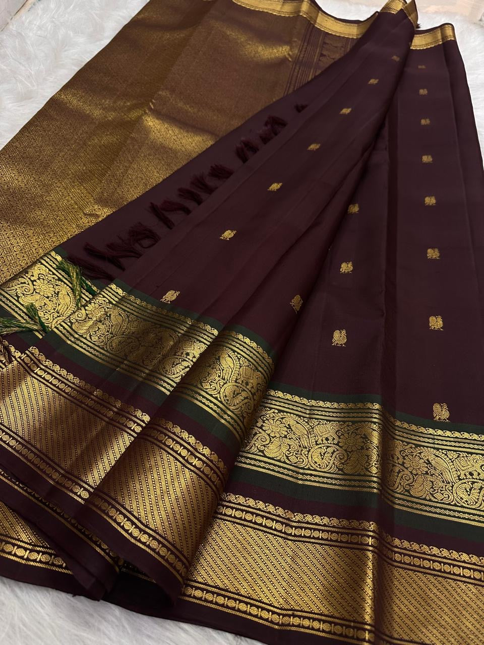 Deep Plum Kancheepuram silk saree folded, showing border and pallu