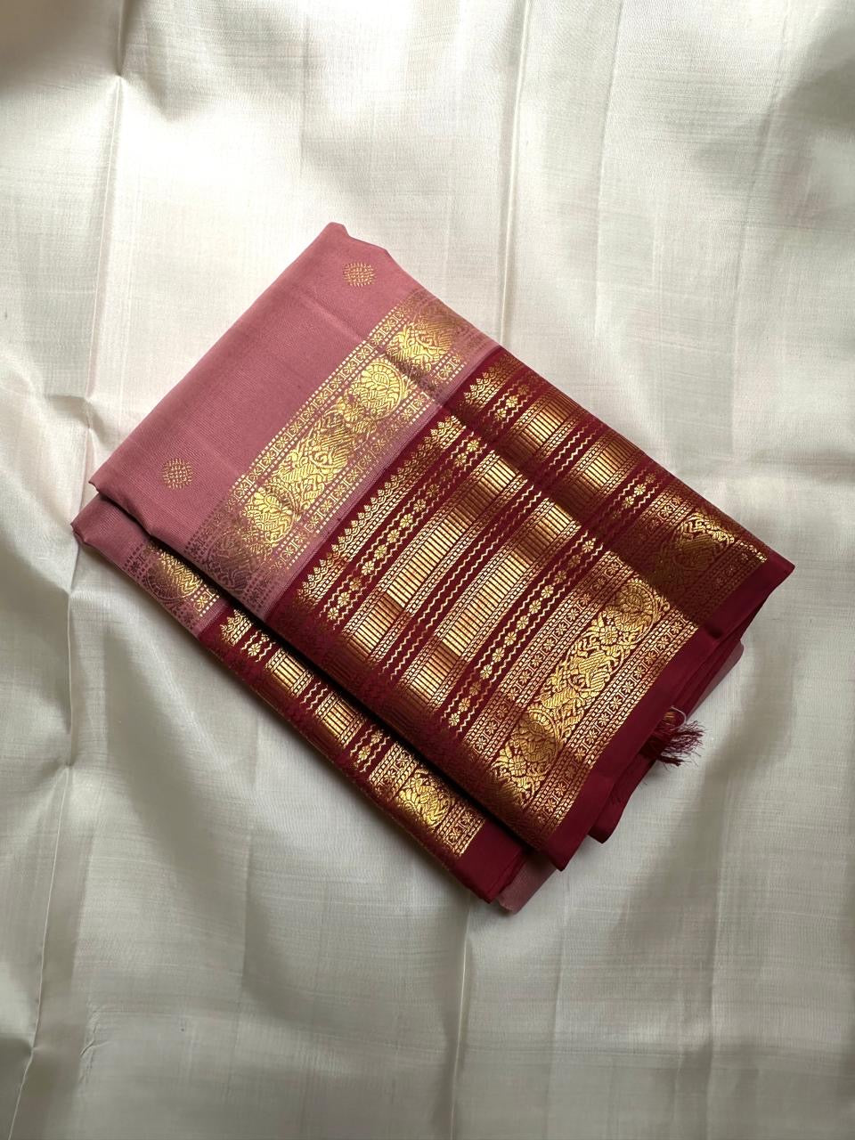Dusty rose Kanchi Pattu saree draped, showing Varisaipet body weave