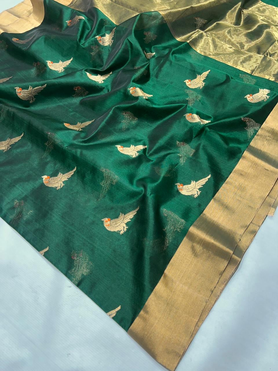 Festive emerald green Chanderi handloom saree with refined zari work and graceful silk texture