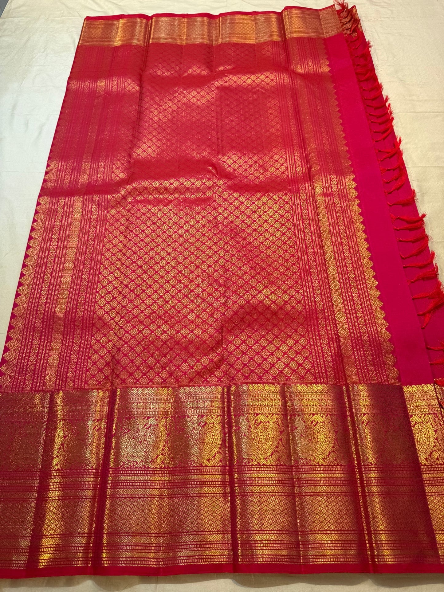 Raspberry Pink pure silk Kanjipuram saree — floral gold zari butta close-up