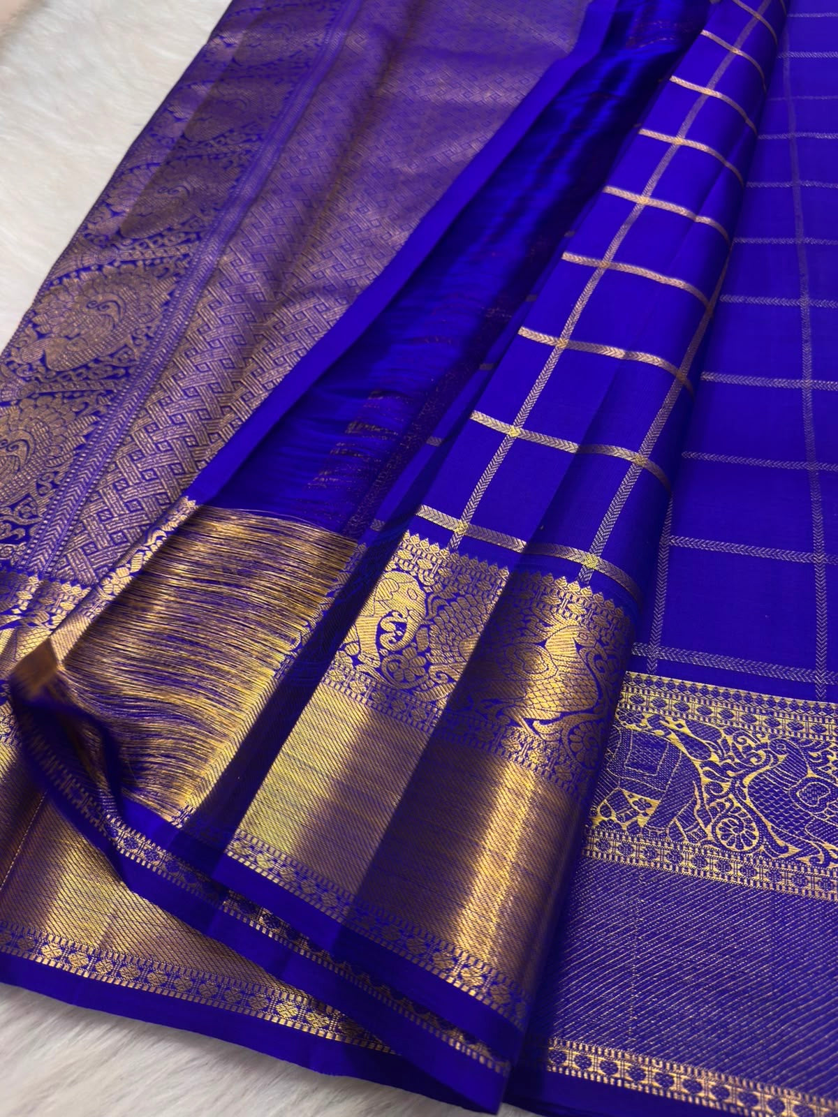 Grand antique gold zari pallu of Deep Violet Zari Kattam Kanchipuram saree with geometric weaving and ornate floral registers.