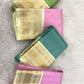 Green handwoven Kanchipuram saree with broad ivory and gold contrast border
