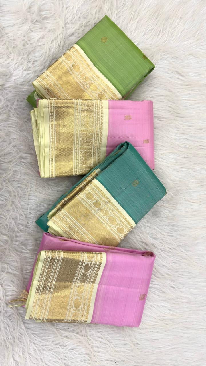 Green handwoven Kanchipuram saree with broad ivory and gold contrast border