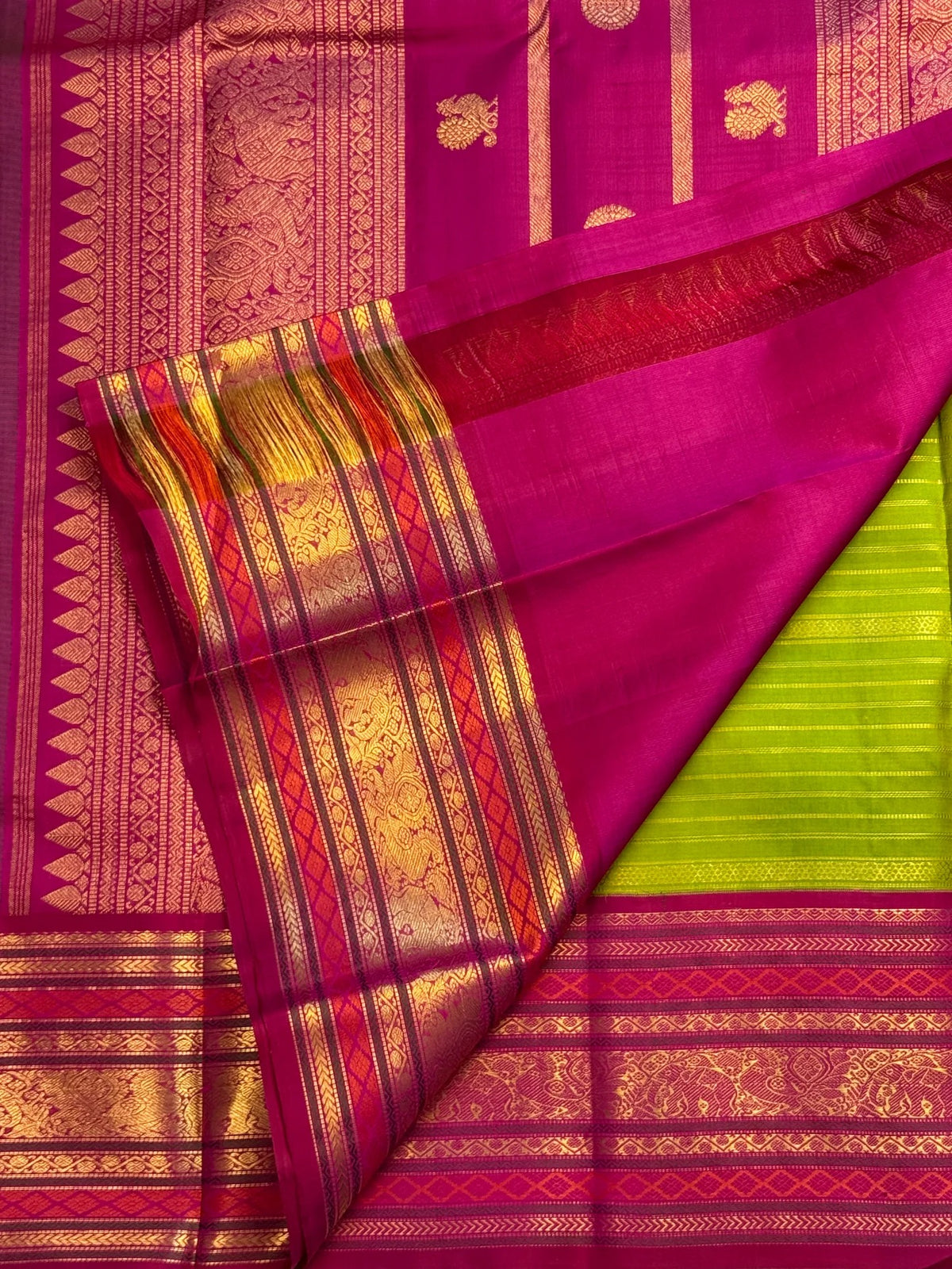 Luminous Vairaoosi zari stripes of varying widths on a green handwoven Kanchipuram silk saree.