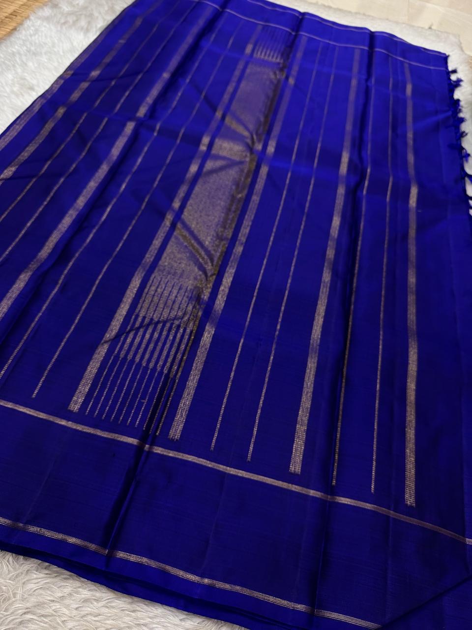 Traditional indigo Kanchi pattu silk saree with antique gold zari accents and richly woven texture
