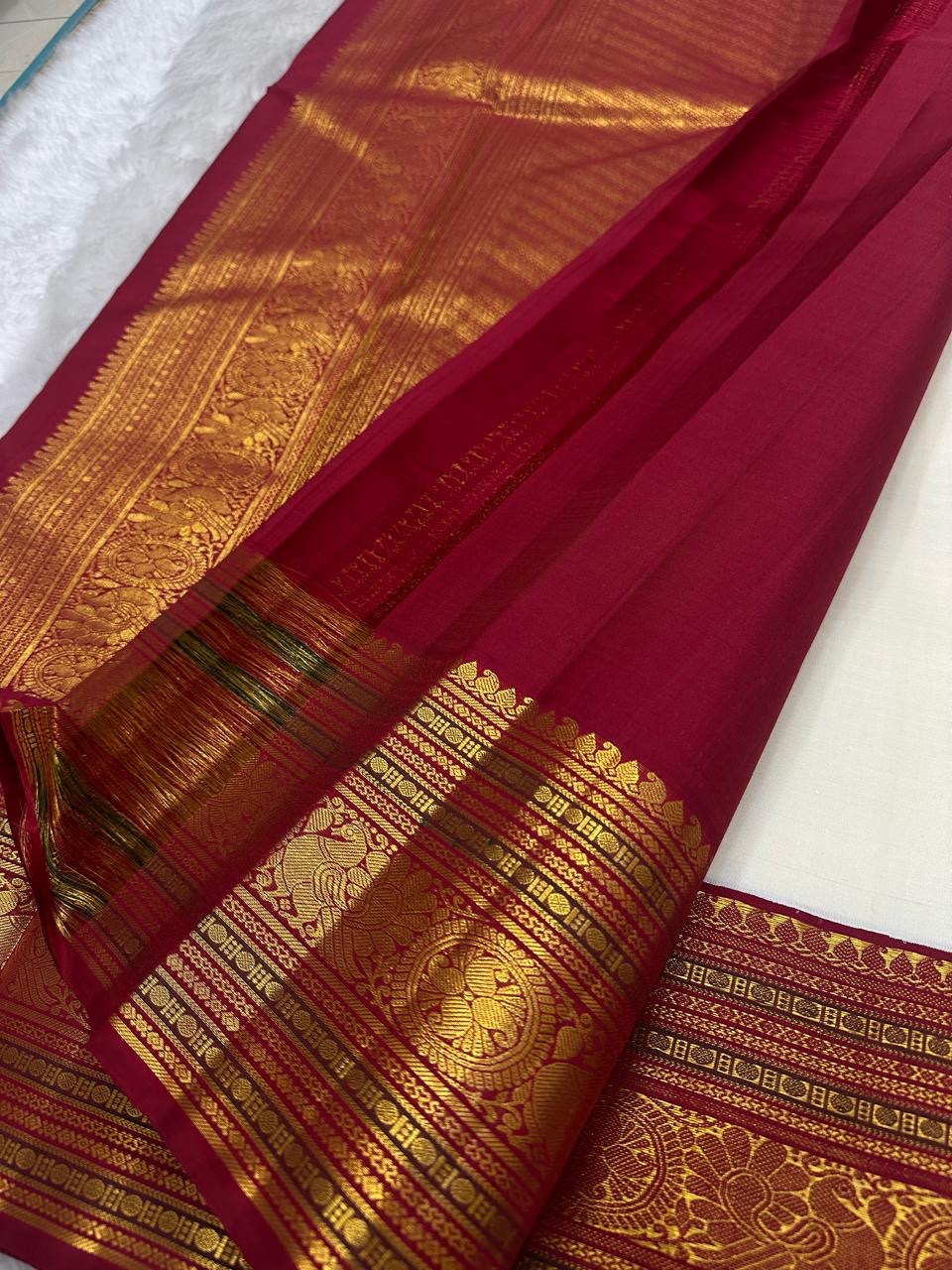 Close view of petite gold maanga buttas on ivory Kanchipuram silk.