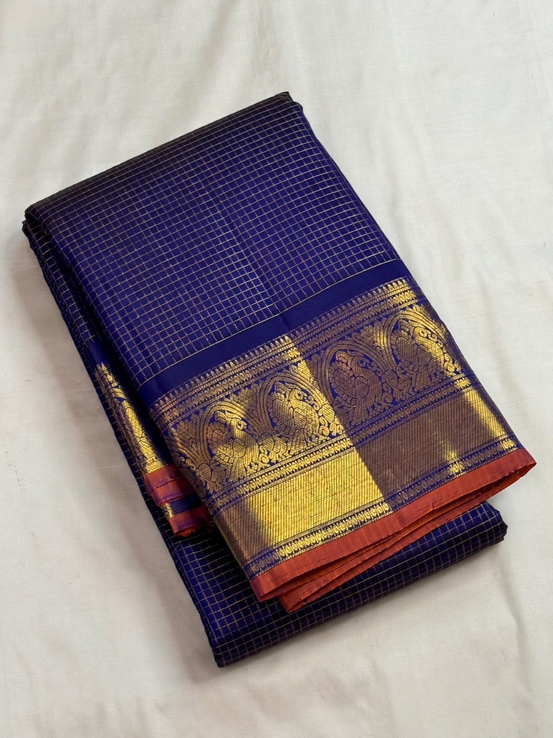 Sorgavaasal Mayil gold-zari border on deep-blue saree