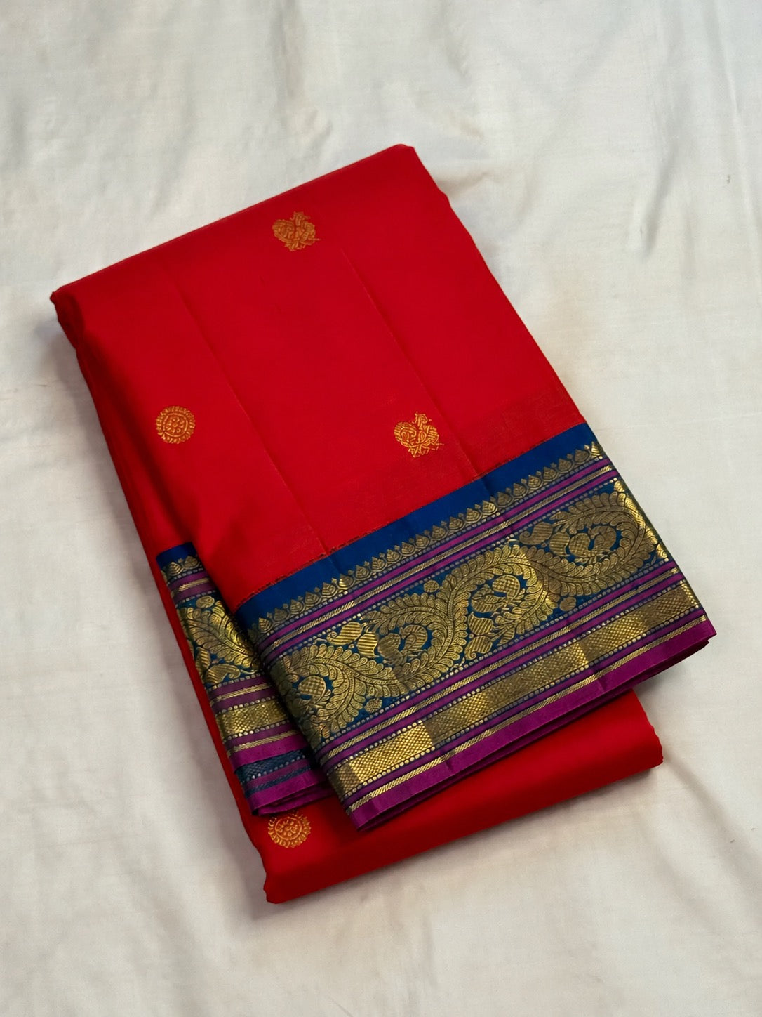 Royal-blue Korvai border on red handwoven Kanchipuram saree