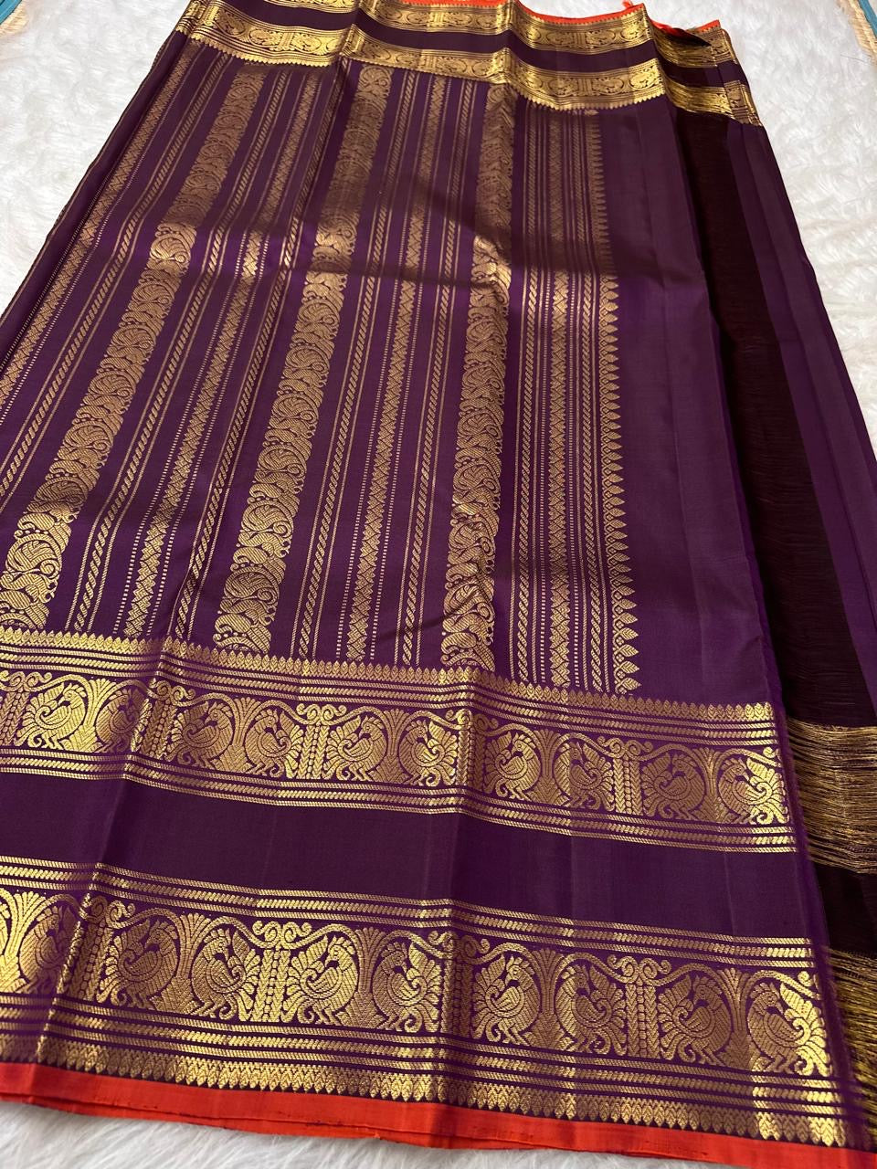 Peacock-plumage Rettapet border with double zari bands on a deep purple handwoven Kanchipuram silk saree