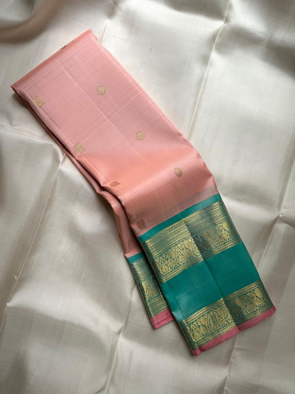 Blush rose Kanjivaram pure silk saree with peacock teal Rettapet border, full drape