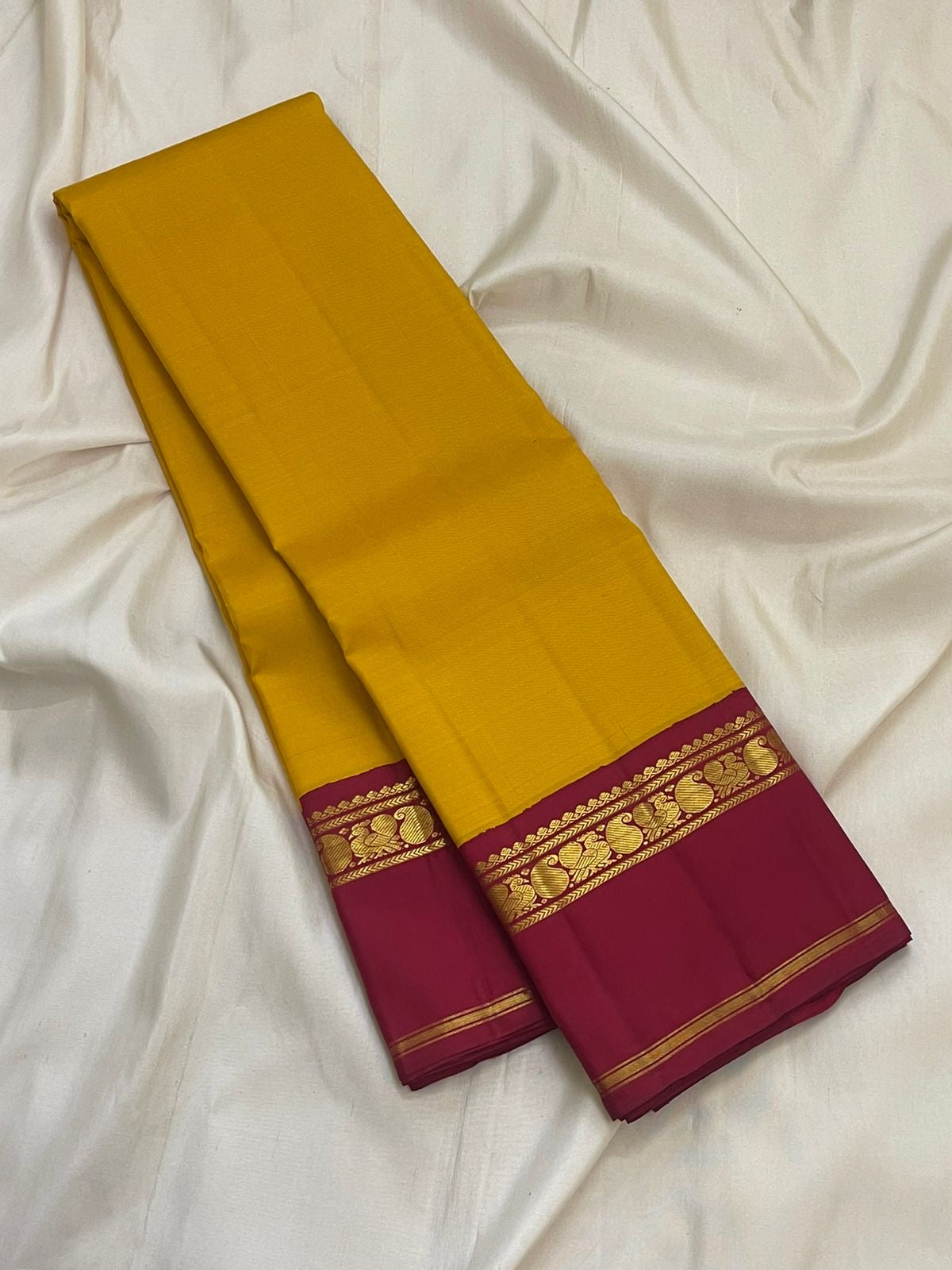 Handwoven pure silk Kanjeevaram saree in canary yellow with arakku red Korvai Kaal Irangiya paisley peacock border Silk Mark certified