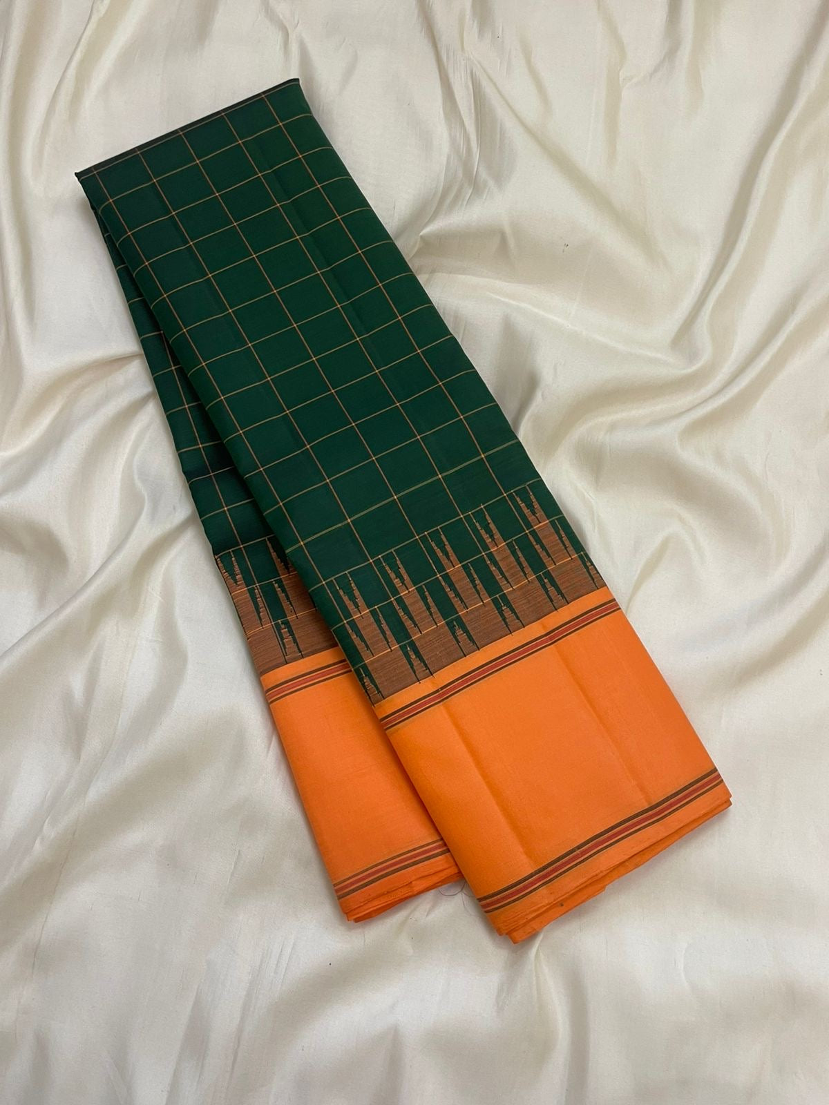 Orange Thazhampoo Reku border of forest green Kanjipuram saree with antique gold zari temple edge and Varisaipet bands