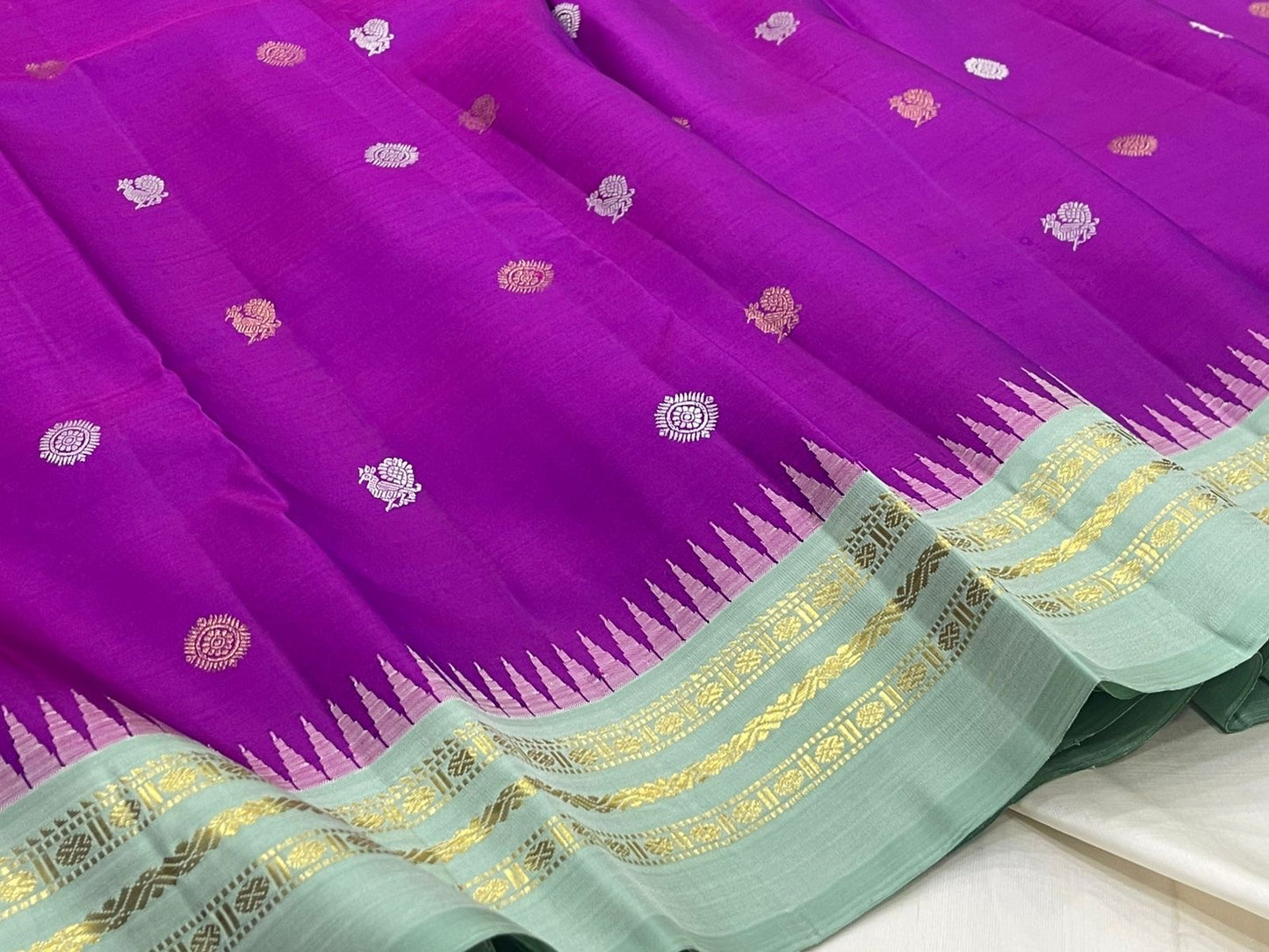 Orchid purple Kanjipuram silk saree body close-up showing Mayil Chakram circular peacock medallion buttas in coloured silk thread