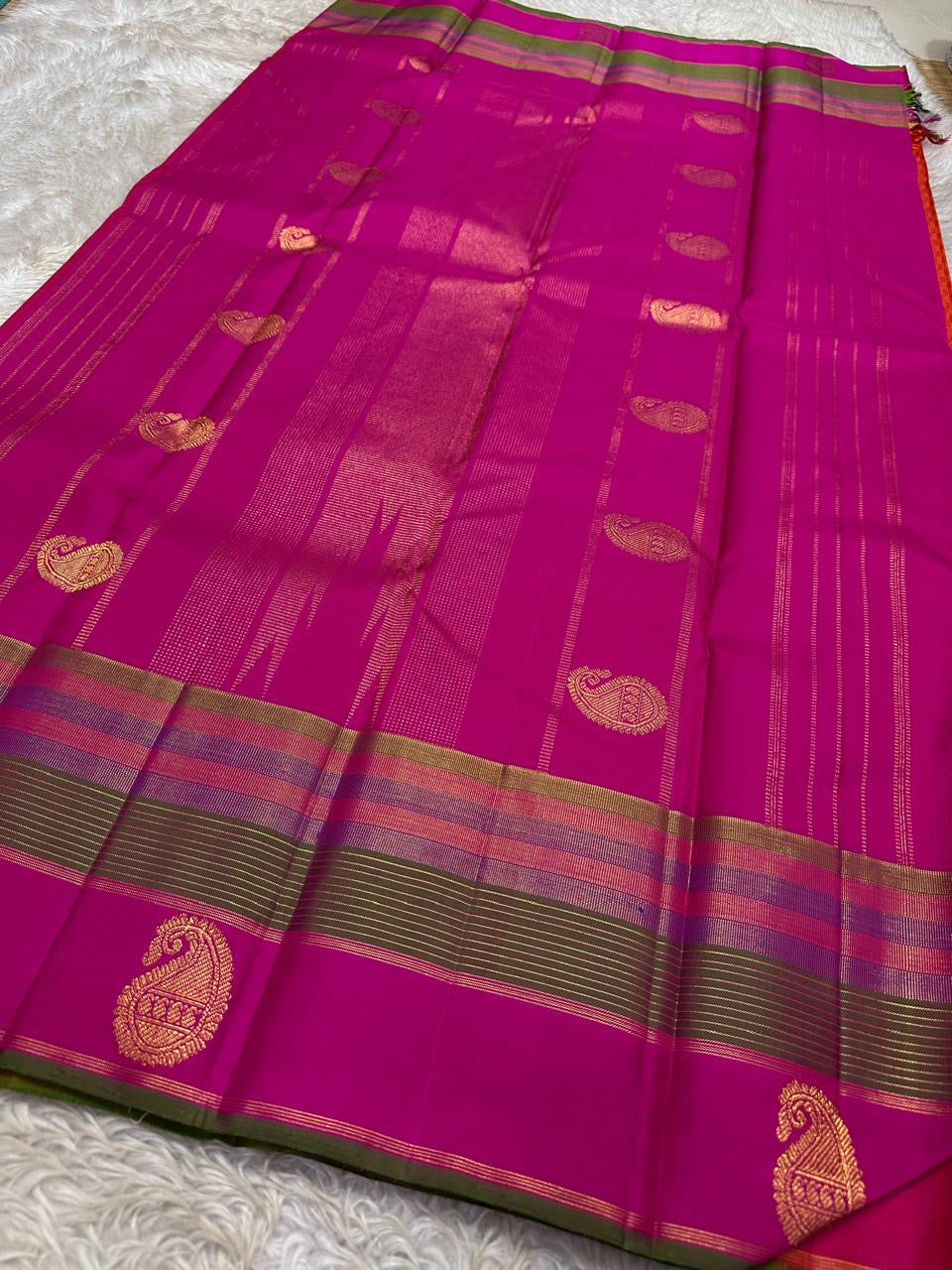 Butta Kanjivaram saree with checked body, geometric border and traditional maanga zari detailing.
