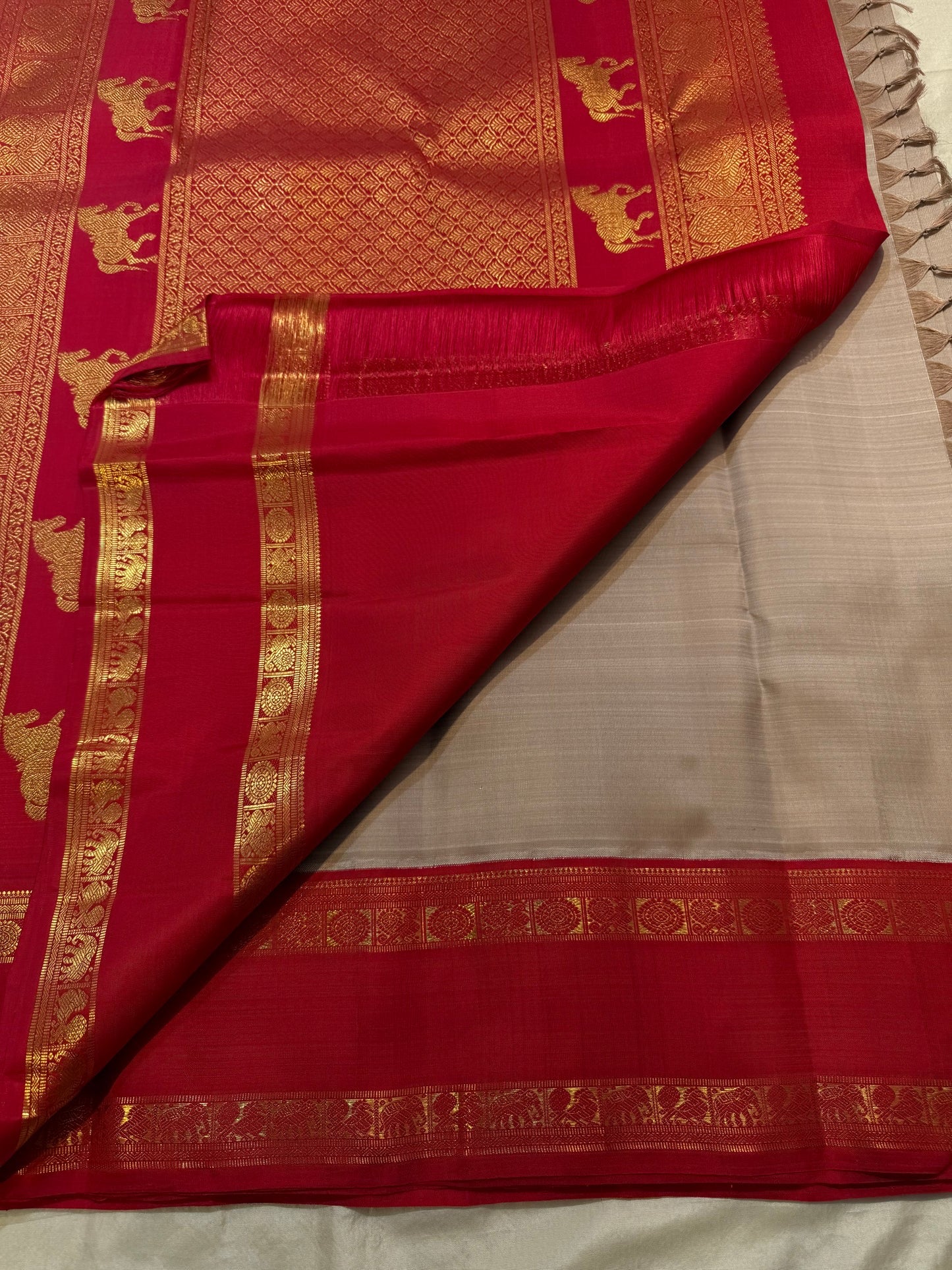 Close-up of gold zari floral medallion buttas on Biscuit Beige Kancheepuram silk saree body
