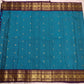 Close view of handwoven gold zari buttas on Turquoise Blue Korvai saree