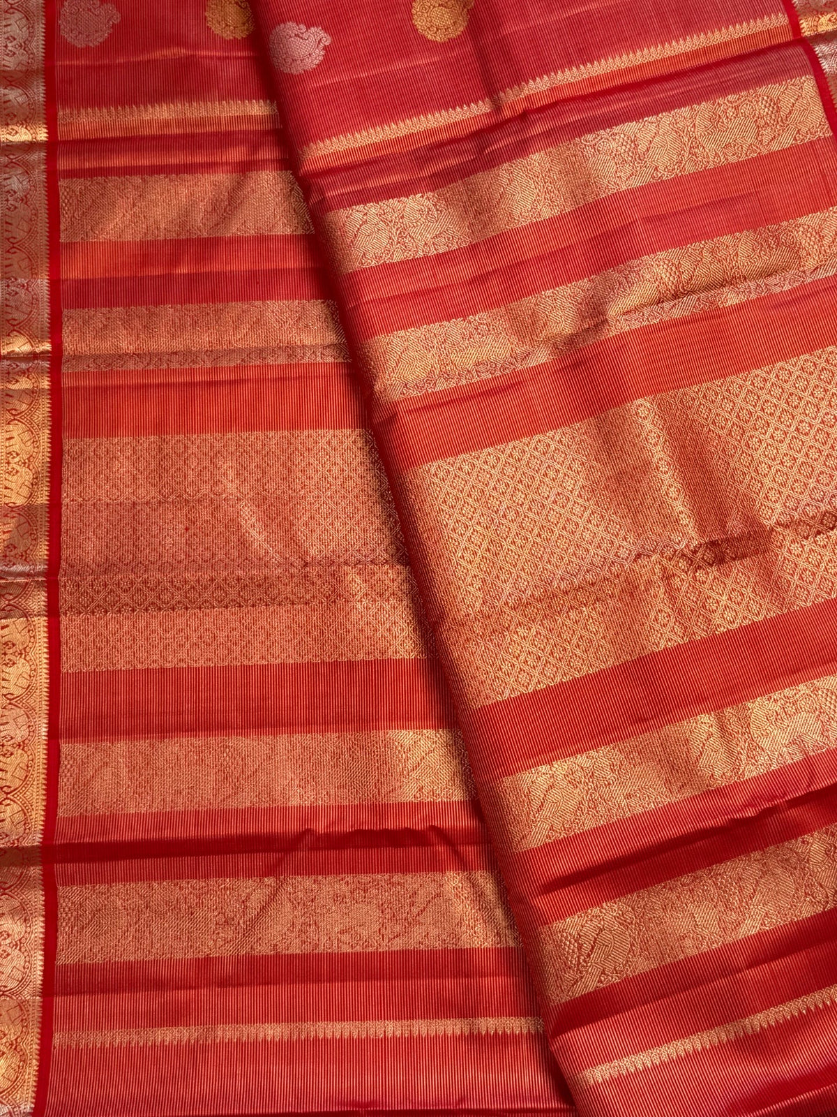 Close view of glowing kungumam red pure silk with fine needle-like Vairaoosi lines