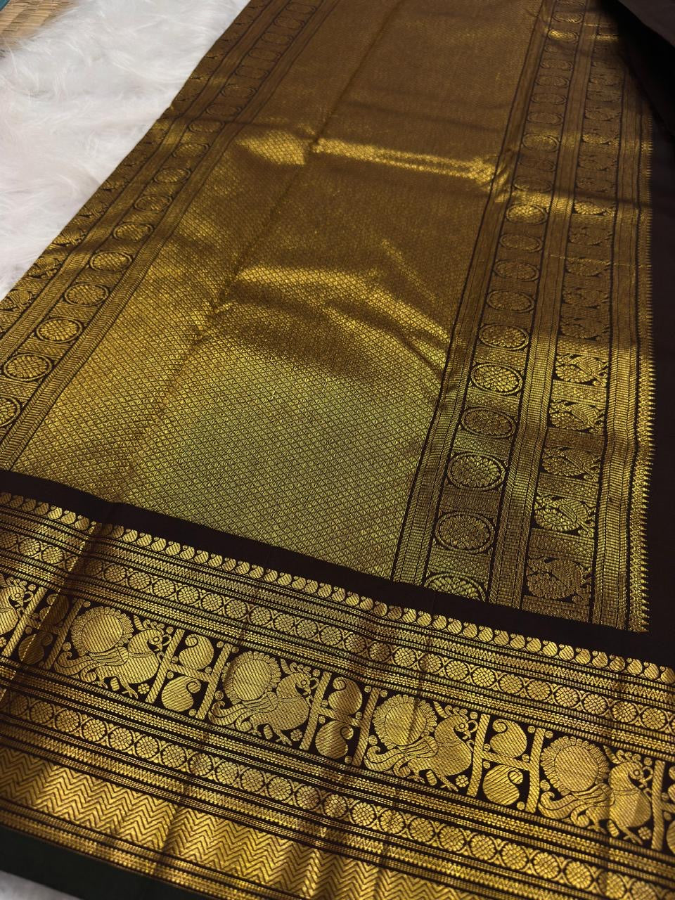 Handwoven cinnamon brown Kanjeevaram silk saree, folded view