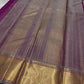 Handwoven magenta Kanchipuram saree with gold zari and a contrasting pallu.