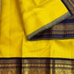 Close view of bright turmeric-yellow Kanjivaram silk showing closely placed Vairaoosi lines