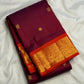 Alternating gold-zari buttas across garnet-maroon silk.