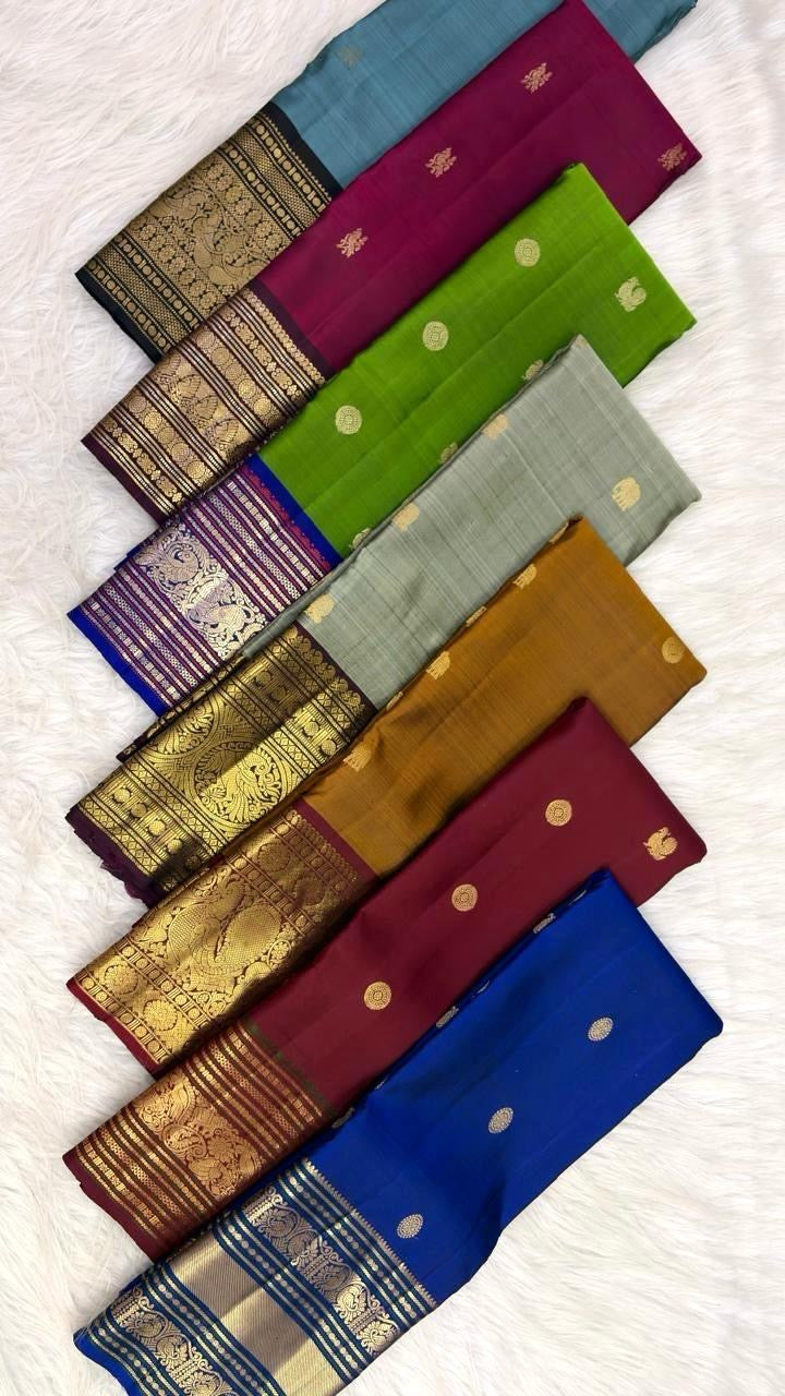 Handwoven mustard Kanchipuram saree showing the peacock and floral kodi border.