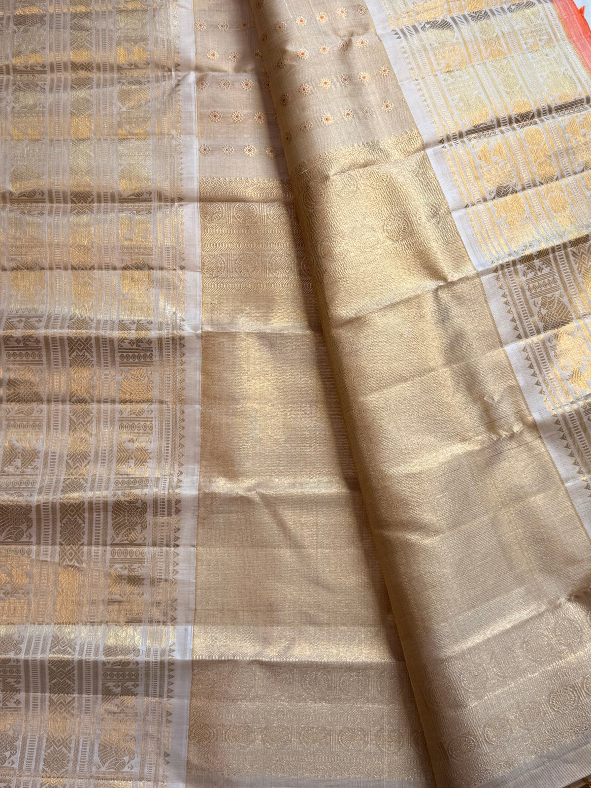 Pale gold handwoven Pure Silk Kanjeevaram Butta saree with orange Meenakari Kamalam motifs and coral-orange selvedge, body weave detail
