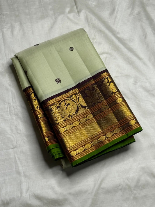 Dark silk thread mayil chakram butta on pistachio green Kanchi Pattu silk saree body — Idam Living