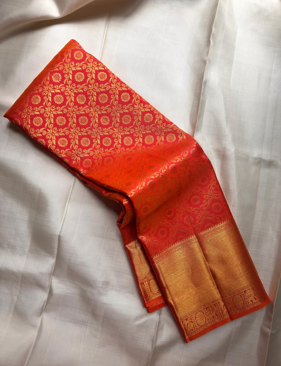 Sunset orange vermillion Kancheepuram saree with vermilion orange zari border, close view