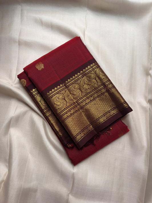 Handwoven ruby red Kanjipuram saree with cinnamon brown Korvai border.