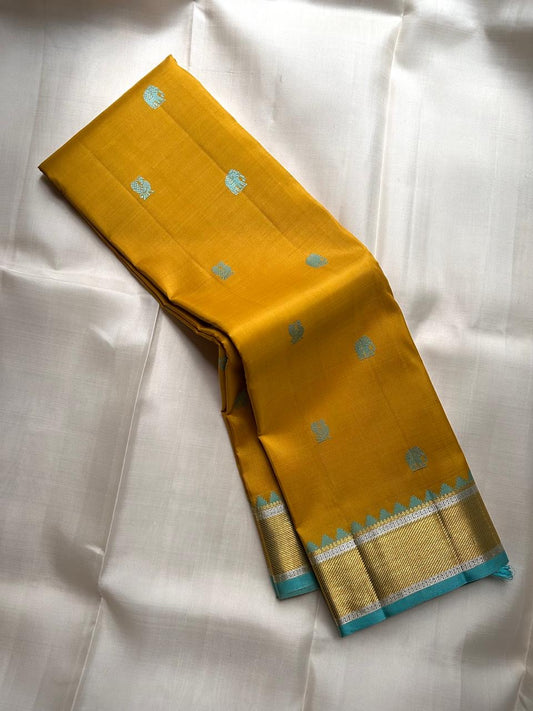 Golden Turmeric Kancheepuram silk saree with robin egg blue Mayil-Yaanai buttas — Idam Living