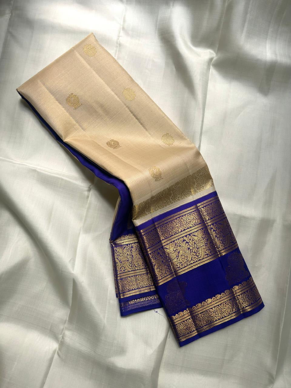 Handwoven pure silk Kanchi Pattu saree in royal ivory with royal blue Korvai Vanasringaram zari motifs — Idam Living