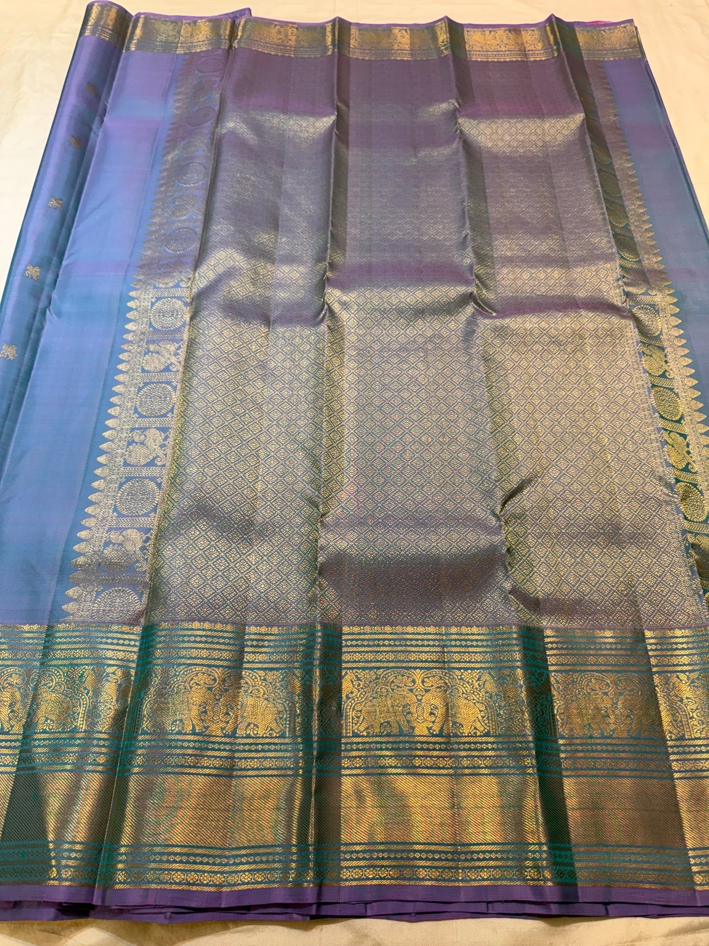 Full drape of handwoven Twilight Periwinkle Kanjivaram silk saree with Gandaberunda and winged horse buttas