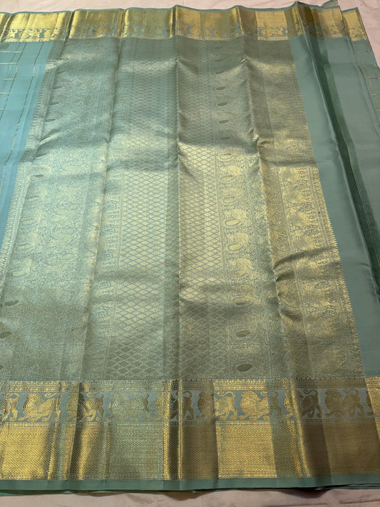 Handwoven dewdrop sage green Kanjeevaram saree with Zari Kattam weave.