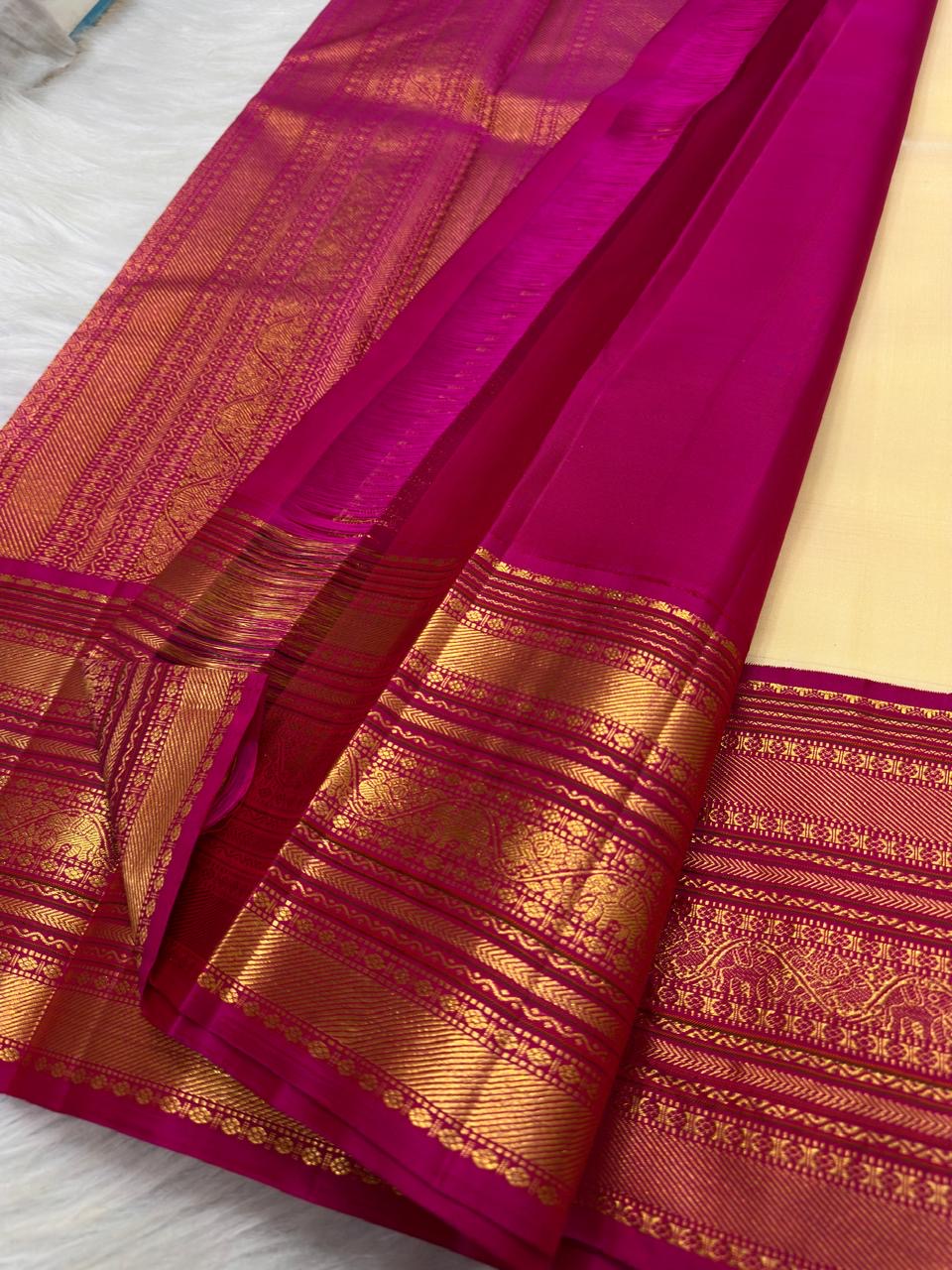 Handwoven pure silk Kanjipuram saree in warm ivory with a layered magenta zari border