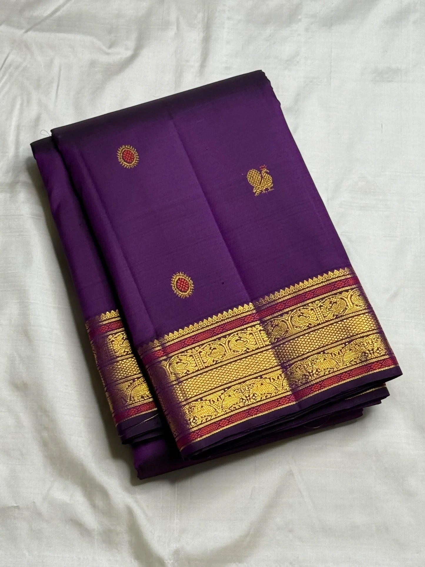 Handwoven purple Kanjeevaram saree – meenakari butta closeup showing intricate zari motifs