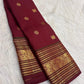 Handwoven deep red Kanchipuram Varisaipet silk saree with an ornate gold-zari border.