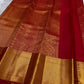 Pillar box red Kancheepuram saree draped, showing zari kattam grid weave