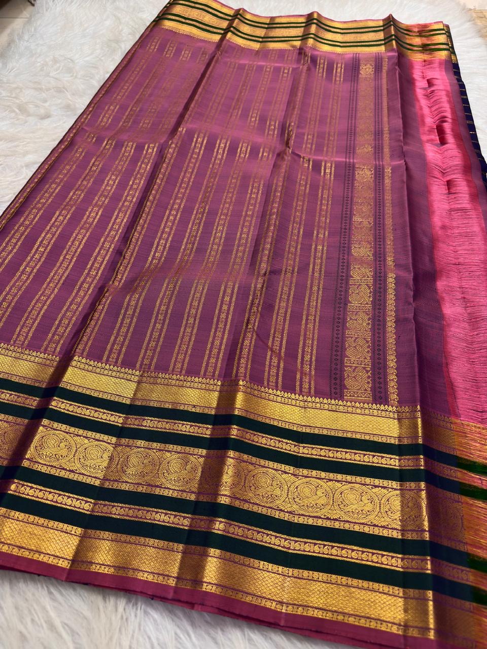 Handwoven royal blue Kanchipuram Varisaipet saree with deep-green border and gold zari.