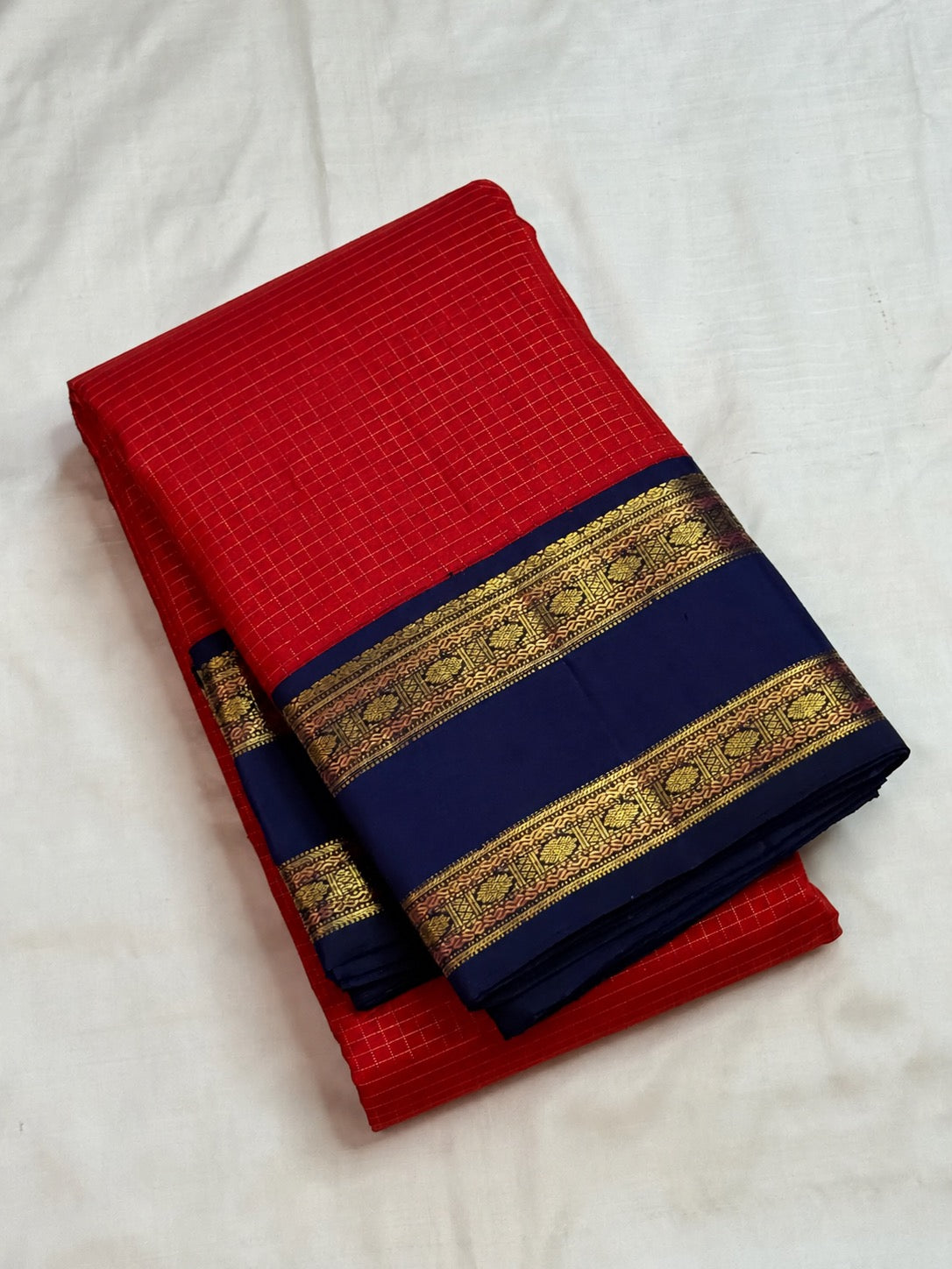 Luminous zari kattam on the deep vibrant red body of a handwoven Pure Silk Kanchipuram saree.