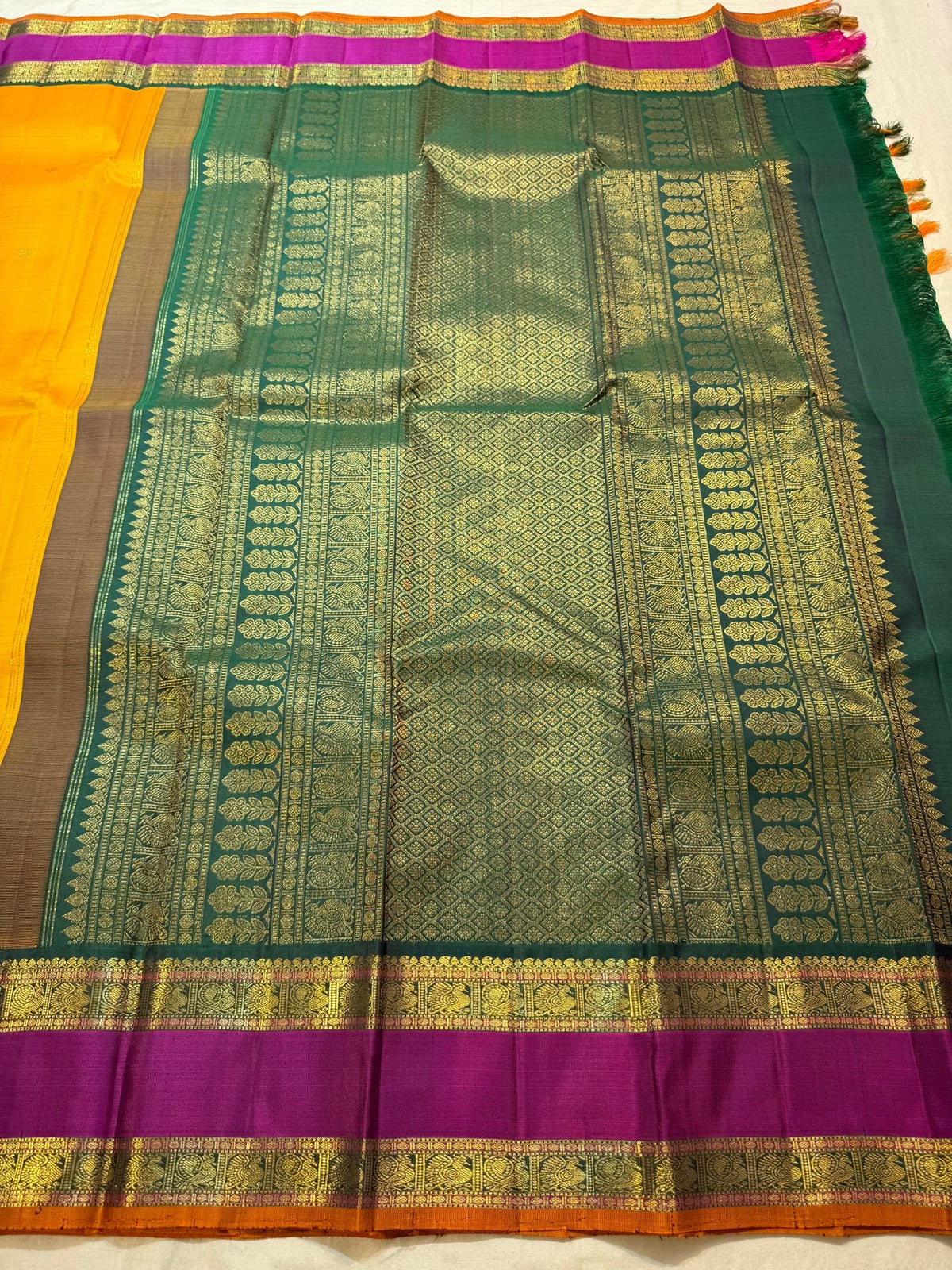 Close view of petite zari buttas on Turmeric Yellow silk body