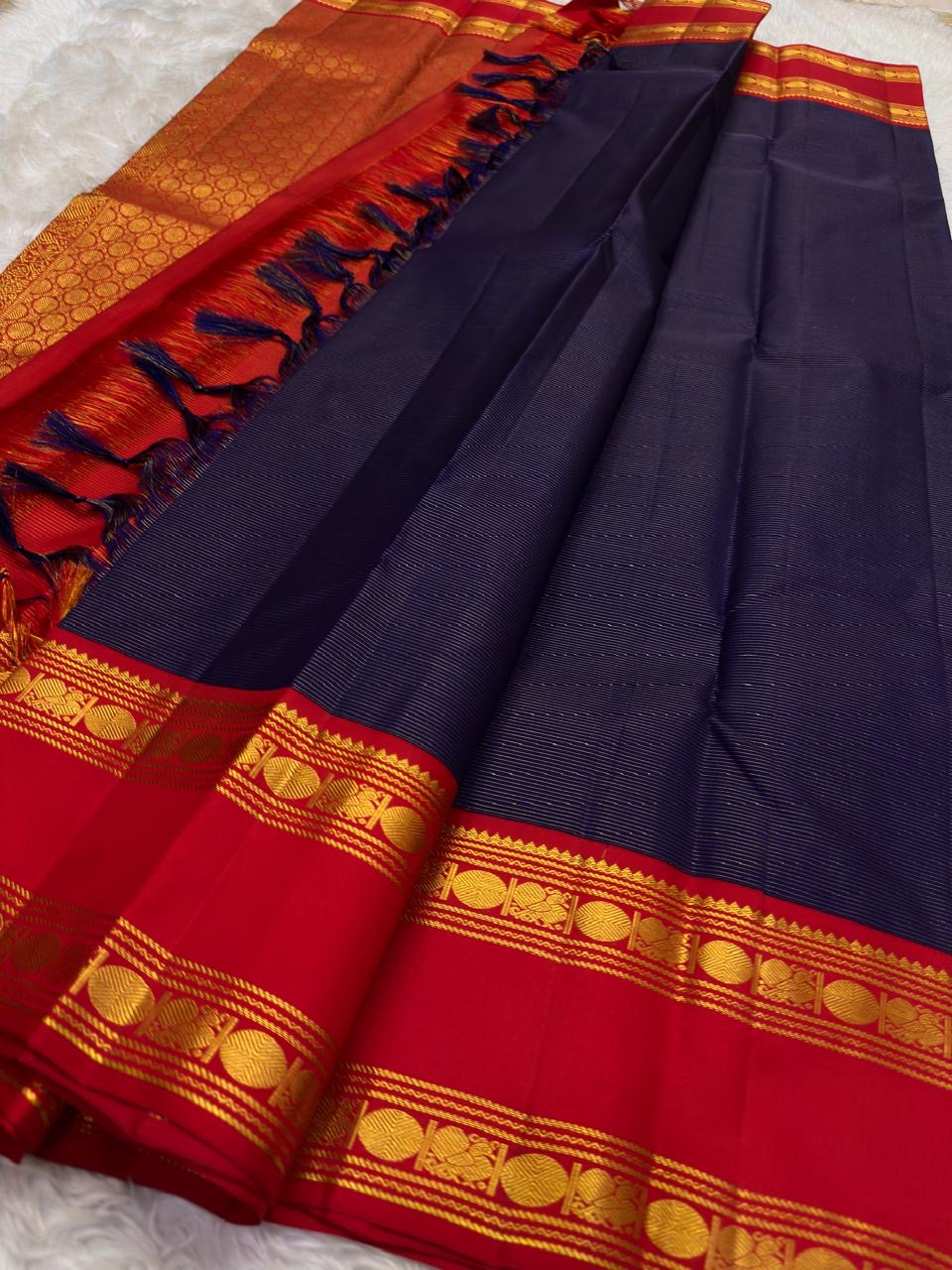 Vairaoosi weave close-up on deep navy KanchiPattu silk saree body, needle-like zari shimmer