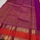 Handwoven sunflower-yellow Korvai Kancheepuram saree with saturated purple and coral contrast.